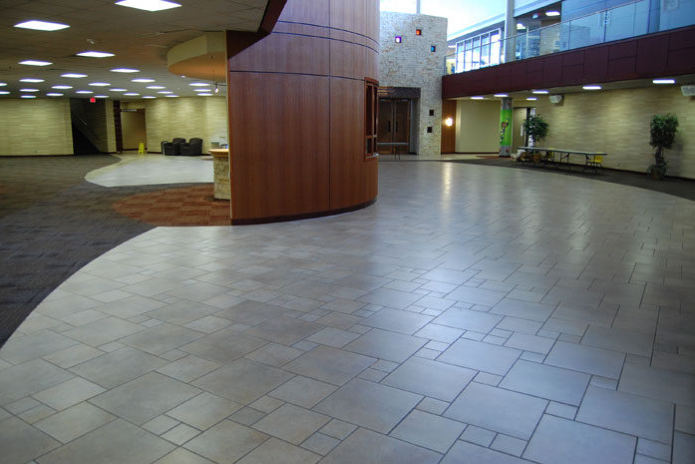 The Hills Church, lobby with a curved wood wall and a large-format tile floor