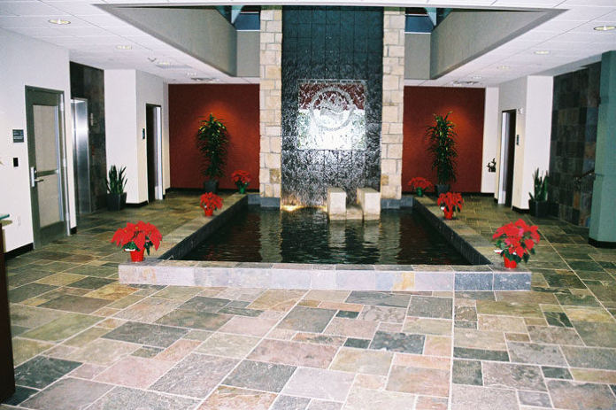 Irving Municipal Complex, lobby with a slate floor and a stone-clad water feature