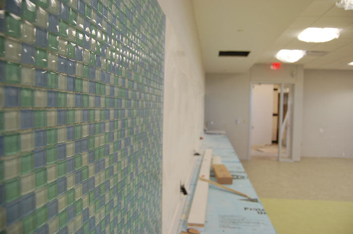 Texas Woman's University Stroke Center, glass mosaic wall in blues and greens beside a corridor