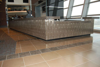 Cowboys Stadium, mosaic-faced concession counter and tiled concourse floor